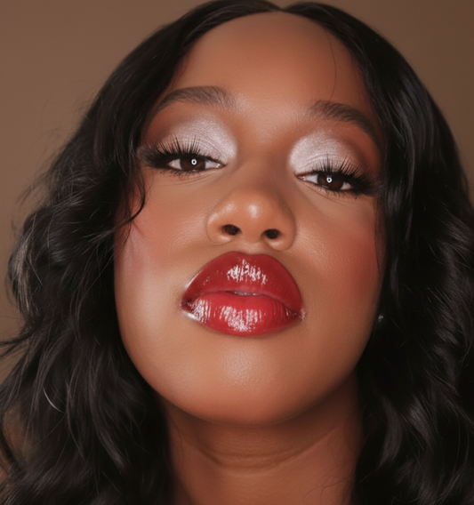 Close-up of a woman with red non sticky lipstick against a brown background