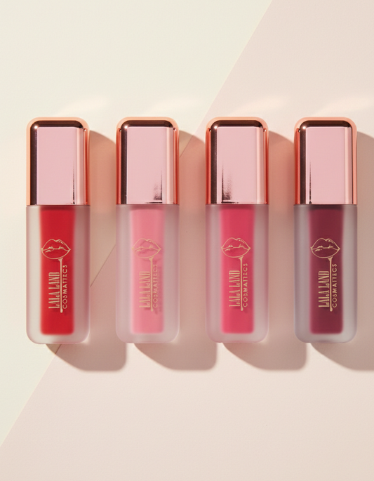 Four vegan liquid blushes with rose gold caps on a light background